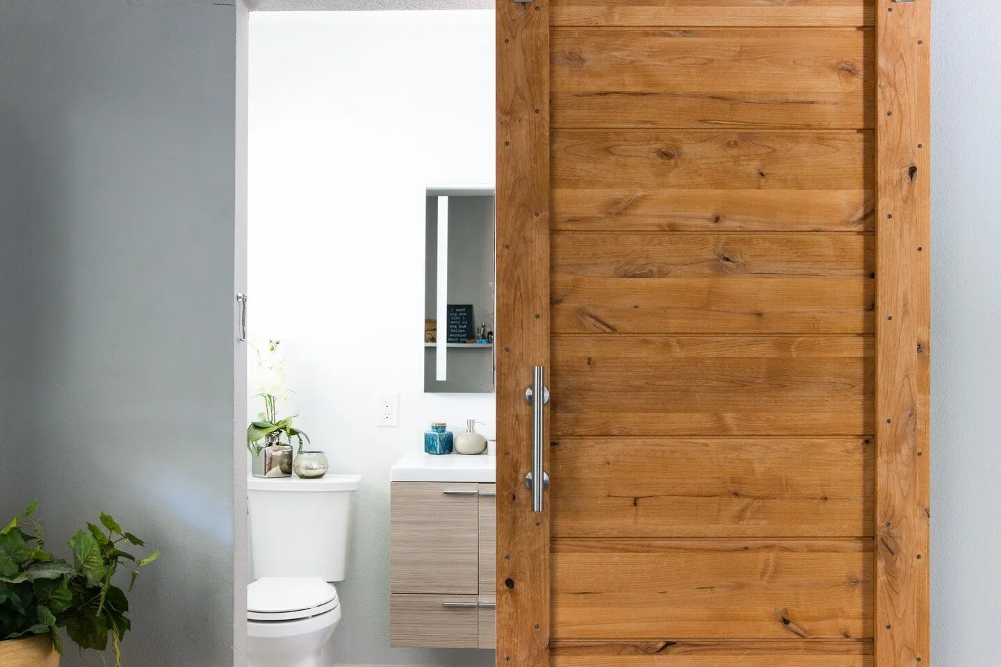 Between the sliding barn door, floating vanity, and spacious walk-in shower, we're having hard time picking our favorite part from this gorgeous bathroom remodel!⁠ .⁠ .⁠ .⁠ #bathroomremodel #bathroomrenovation #bathroomideas #bathroominspiration #bat